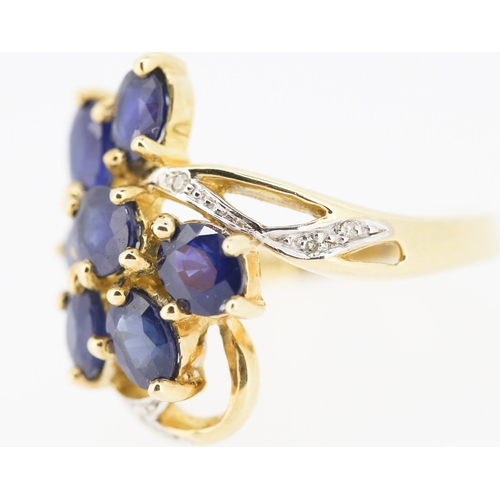 306 - Sapphire Set Seven Stone Floral Form Ring Set in 9 Carat Yellow Gold with Further Diamonds to Settin... 