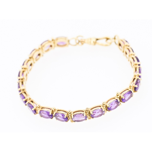 35 - Amethyst Nineteen Stone Set Bracelet Mounted in 9 Carat Yellow Gold 18.5cm Long