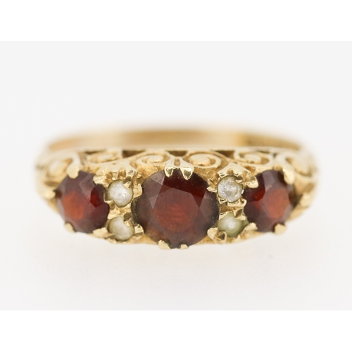 419 - Red Garnet Three Stone Ring with Further Gemstone Insets Mounted in 9 Carat Yellow Gold Ring Size M ... 