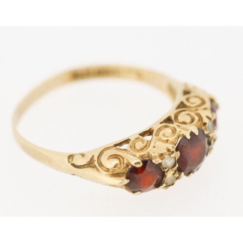 419 - Red Garnet Three Stone Ring with Further Gemstone Insets Mounted in 9 Carat Yellow Gold Ring Size M ... 