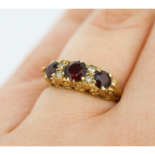 419 - Red Garnet Three Stone Ring with Further Gemstone Insets Mounted in 9 Carat Yellow Gold Ring Size M ... 