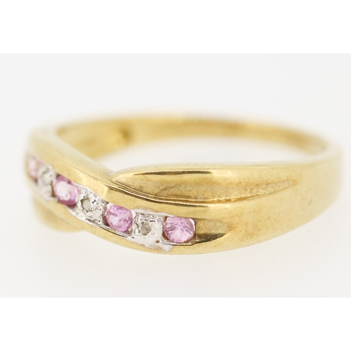 423 - Pink Sapphire and Diamond Set Crossover Motif Ring Mounted in 9 Carat Yellow Gold Ring Size P