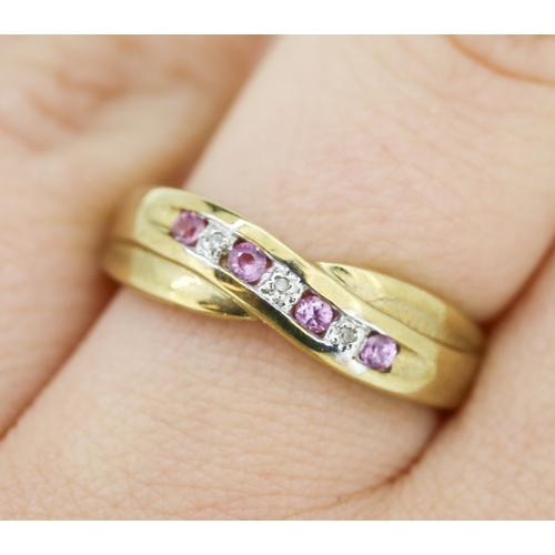 423 - Pink Sapphire and Diamond Set Crossover Motif Ring Mounted in 9 Carat Yellow Gold Ring Size P