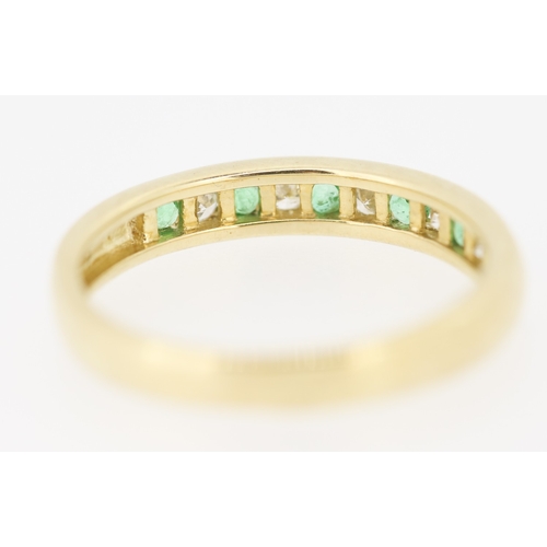 432 - Emerald and Diamond Channel Set Half Eternity Ring Mounted in 9 Carat Yellow Gold Ring Size N