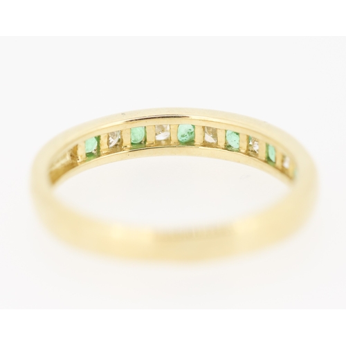 432 - Emerald and Diamond Channel Set Half Eternity Ring Mounted in 9 Carat Yellow Gold Ring Size N