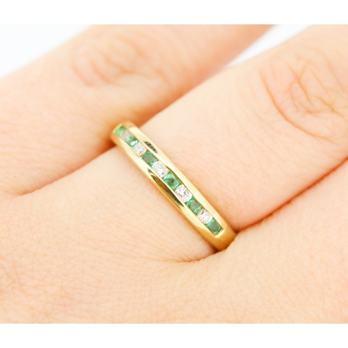 432 - Emerald and Diamond Channel Set Half Eternity Ring Mounted in 9 Carat Yellow Gold Ring Size N