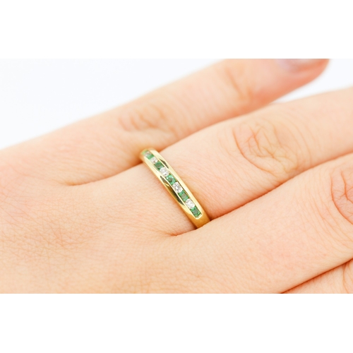 432 - Emerald and Diamond Channel Set Half Eternity Ring Mounted in 9 Carat Yellow Gold Ring Size N