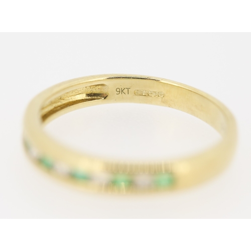 432 - Emerald and Diamond Channel Set Half Eternity Ring Mounted in 9 Carat Yellow Gold Ring Size N