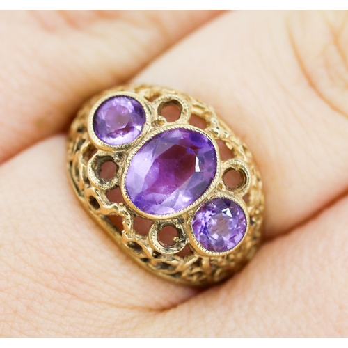 503 - Three Stone Bezel Set Amethyst Ring Mounted on 9 Carat Yellow Gold Openwork Scroll Setting Ring Size... 