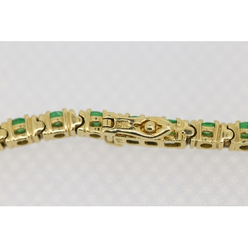 62 - Emerald Thirty Two Stone Set Tennis Bracelet Mounted in 18 Carat Yellow Gold 17.5cm Long