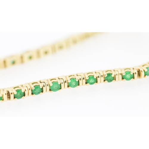 62 - Emerald Thirty Two Stone Set Tennis Bracelet Mounted in 18 Carat Yellow Gold 17.5cm Long