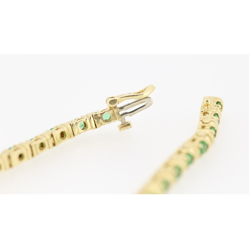 62 - Emerald Thirty Two Stone Set Tennis Bracelet Mounted in 18 Carat Yellow Gold 17.5cm Long