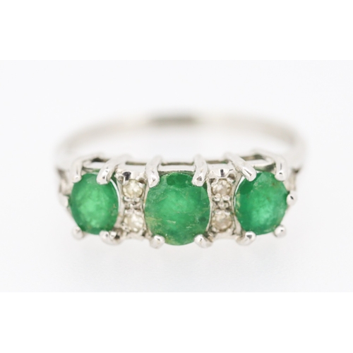 80 - Emerald Three Stone Ring with Diamond Insets Mounted in 18 Carat White Gold Ring Size P and a Half