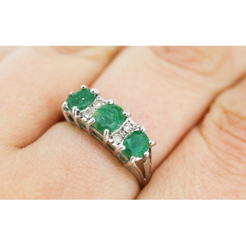 80 - Emerald Three Stone Ring with Diamond Insets Mounted in 18 Carat White Gold Ring Size P and a Half