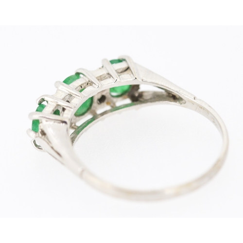 80 - Emerald Three Stone Ring with Diamond Insets Mounted in 18 Carat White Gold Ring Size P and a Half