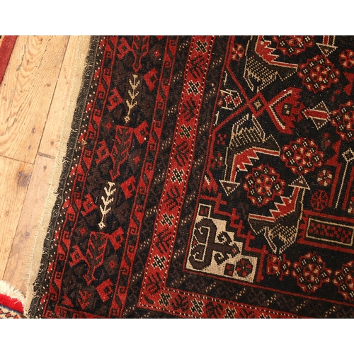 854 - Persian Pure Wool Rug Burgundy and Navy Ground Patterned Borders Approximately 5ft Long x 3ft Wide