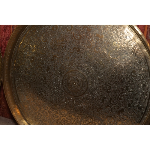 864 - Two Eastern Engraved Cast Brass Benares Trays Circular Form Largest Approximately 21 Inches Diameter