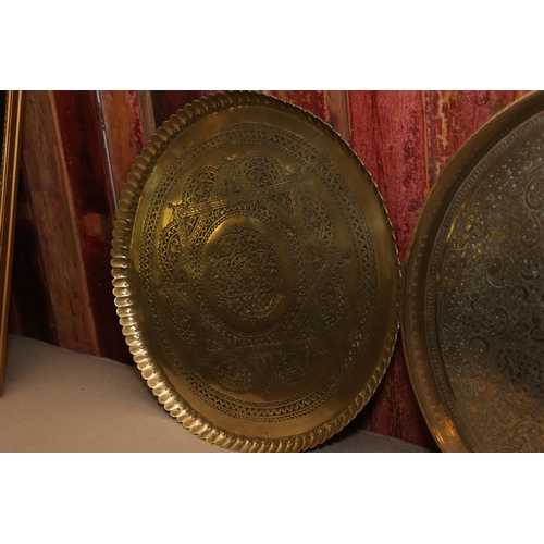 864 - Two Eastern Engraved Cast Brass Benares Trays Circular Form Largest Approximately 21 Inches Diameter