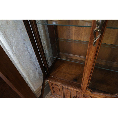 943 - Walnut Two Door Display Cabinet Cupboard Base Below Shaped Pediment Interior Lighting Three Glass Sh... 