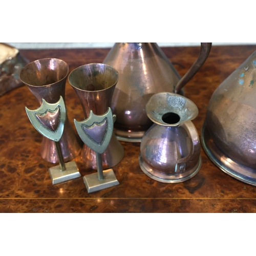 945 - Three Copper Measuring Jugs with Two Copper Napkin Rings with Two Shield Form Stands Seven Pieces in... 