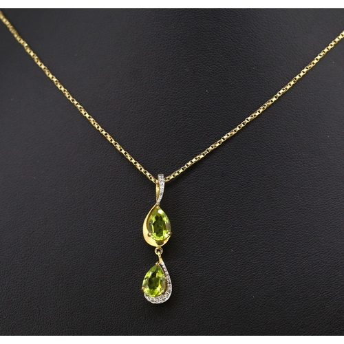 Pear Cut Peridot Twin Stone Set Drop Pendant with Further Diamond Insets Mounted in 9 Carat Yellow Gold 3.5cm Drop Set on 9 Carat Yellow Gold Chain 50cm Long