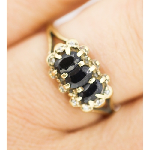127 - Sapphire Three Stone Set Ring with Diamond Set Surround Mounted in 9 Carat Yellow Gold Ring Size N a... 