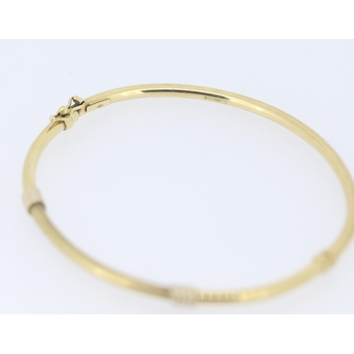 141 - 9 Carat Yellow Gold Bangle Bracelet with White Gold Knot Motifs Inner Width 6.5cm