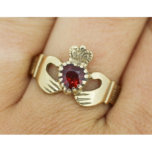 145 - Red Garnet Set Claddagh Ring Mounted in 9 Carat Yellow Gold Ring Size U