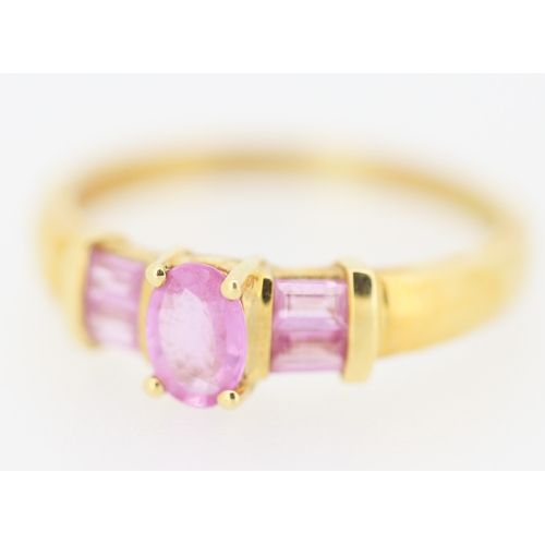 170 - Oval Cut Pink Sapphire Set Ring with Further Baguette Cut Pink Sapphires Set to Shoulders Mounted in... 
