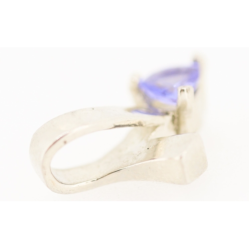 176 - Triangle Cut Tanzanite Set Ribbon Form Pendant Mounted in 9 Carat White Gold 1.5cm High