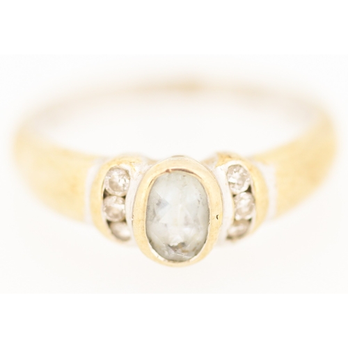 178 - Bezel Set Aquamarine Ring with Diamond Inset to Shoulders Mounted in 9 Carat Yellow Gold Ring Size N