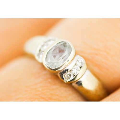 178 - Bezel Set Aquamarine Ring with Diamond Inset to Shoulders Mounted in 9 Carat Yellow Gold Ring Size N