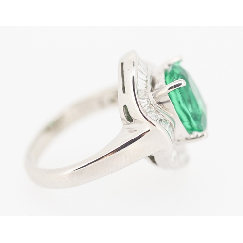 61 - Finely Detailed Emerald Set Centre Stone Ring with Tapered Baguette Cut Diamond Set Halo Surround Mo... 