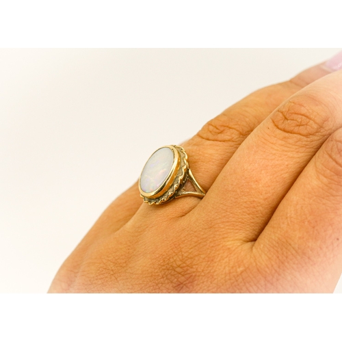 16 - Bezel Set Opal Single Stone Ring Mounted in 9 Carat Yellow Gold Opal 14mm by 10mm Ring Size N and a ... 