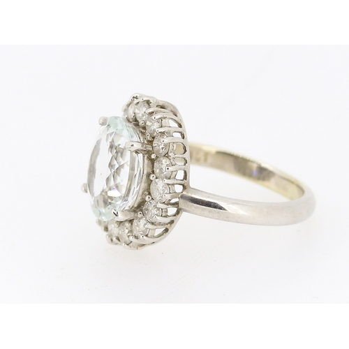 28 - Aquamarine Set Centre Stone Ring with Sixteen Diamond Set Halo Surround Mounted in 18 Carat White Go... 