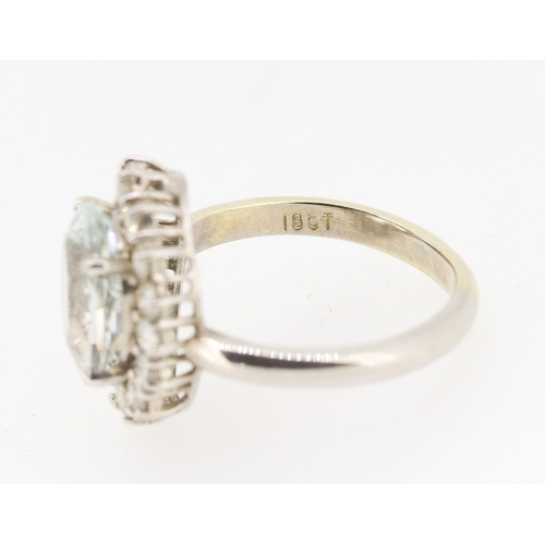 28 - Aquamarine Set Centre Stone Ring with Sixteen Diamond Set Halo Surround Mounted in 18 Carat White Go... 