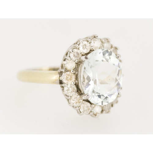 28 - Aquamarine Set Centre Stone Ring with Sixteen Diamond Set Halo Surround Mounted in 18 Carat White Go... 