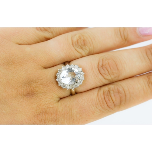 28 - Aquamarine Set Centre Stone Ring with Sixteen Diamond Set Halo Surround Mounted in 18 Carat White Go... 