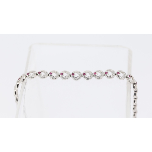 55 - Attractively Detailed Diamond and Ruby Set Crecent Form Ladies Bracelet Mounted in 18 Carat White Go... 