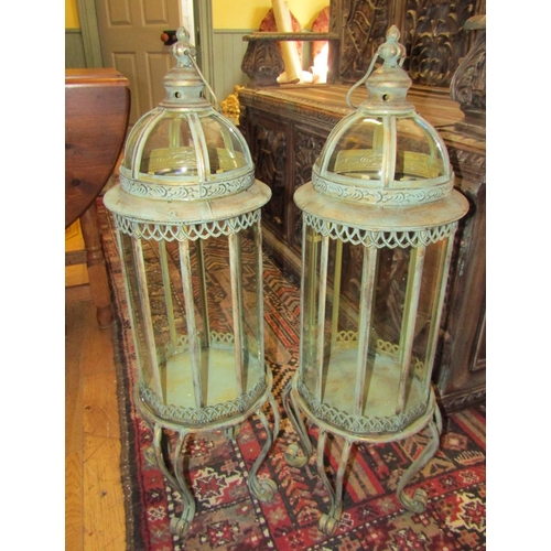 250 - Pair of Glazed Metal Lanterns on Shaped Supports each Approximately 32 Inches High