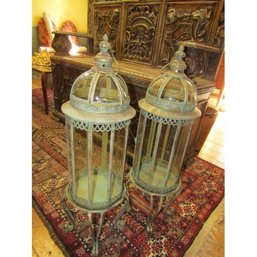 250 - Pair of Glazed Metal Lanterns on Shaped Supports each Approximately 32 Inches High