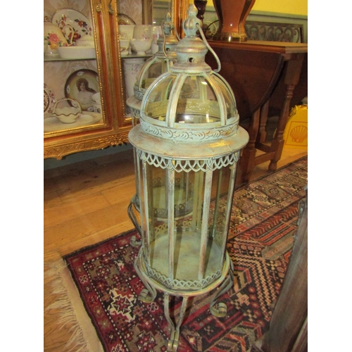 250 - Pair of Glazed Metal Lanterns on Shaped Supports each Approximately 32 Inches High