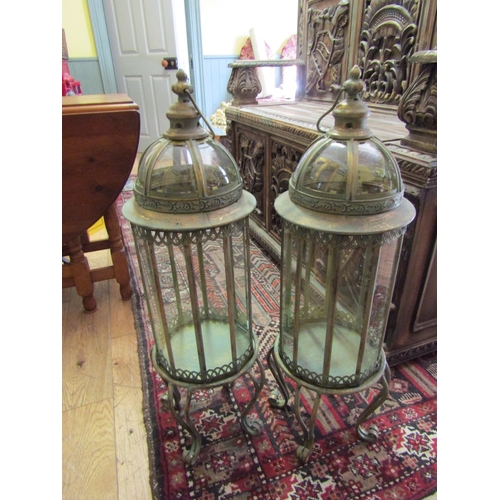 250 - Pair of Glazed Metal Lanterns on Shaped Supports each Approximately 32 Inches High