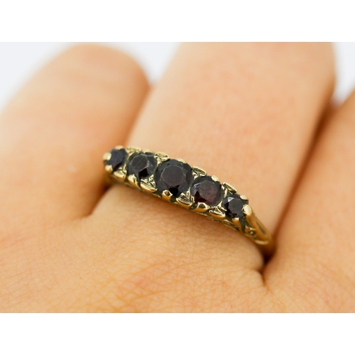 22 - Garnet Set Five Stone Graduated Form Ring Mounted in 9 Carat Yellow Gold Ring Size V