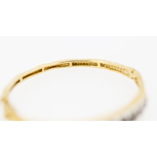 41 - Attractively Detailed Sapphire Nine Stone Set Graduated Form Bangle Bracelet Mounted in 9 Carat Yell... 