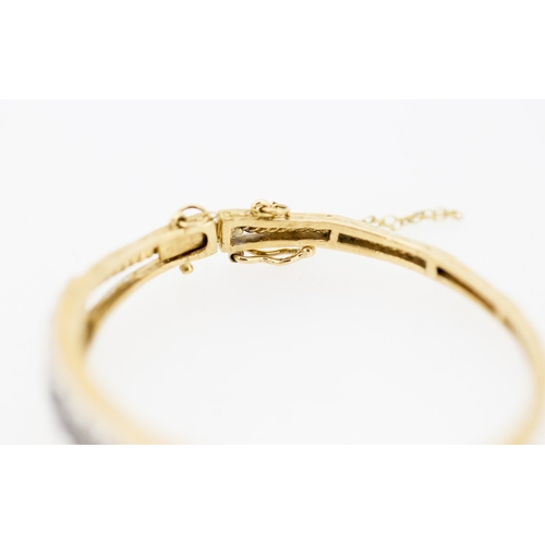 41 - Attractively Detailed Sapphire Nine Stone Set Graduated Form Bangle Bracelet Mounted in 9 Carat Yell... 