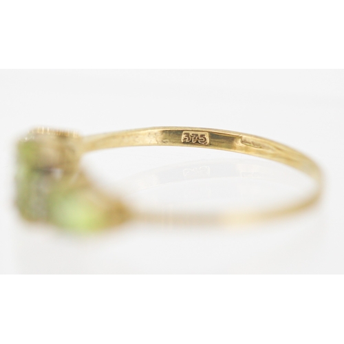 49 - Peridot Set Three Stone Ring with Further Diamond Insets Mounted in 9 Carat Yellow Gold Ring Size T