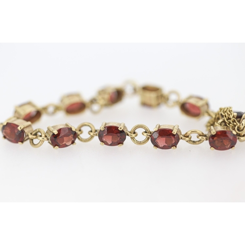 59 - Garnet Eleven Stone Set Bracelet Mounted in 9 Carat Yellow Gold with Safety Chain 16.5cm Long