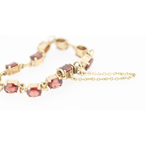 59 - Garnet Eleven Stone Set Bracelet Mounted in 9 Carat Yellow Gold with Safety Chain 16.5cm Long