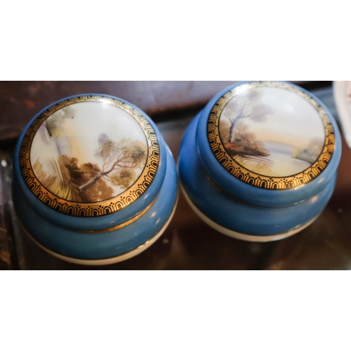 42 - Pair of Finely Detailed Porcelain Table Boxes with Original Covers Decorated with River Scenes Hand ... 